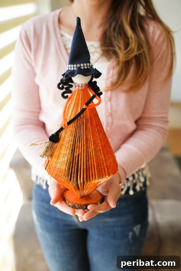 Upcycled Book Floating Witch Halloween Decor 42 Woman holding paper witch
