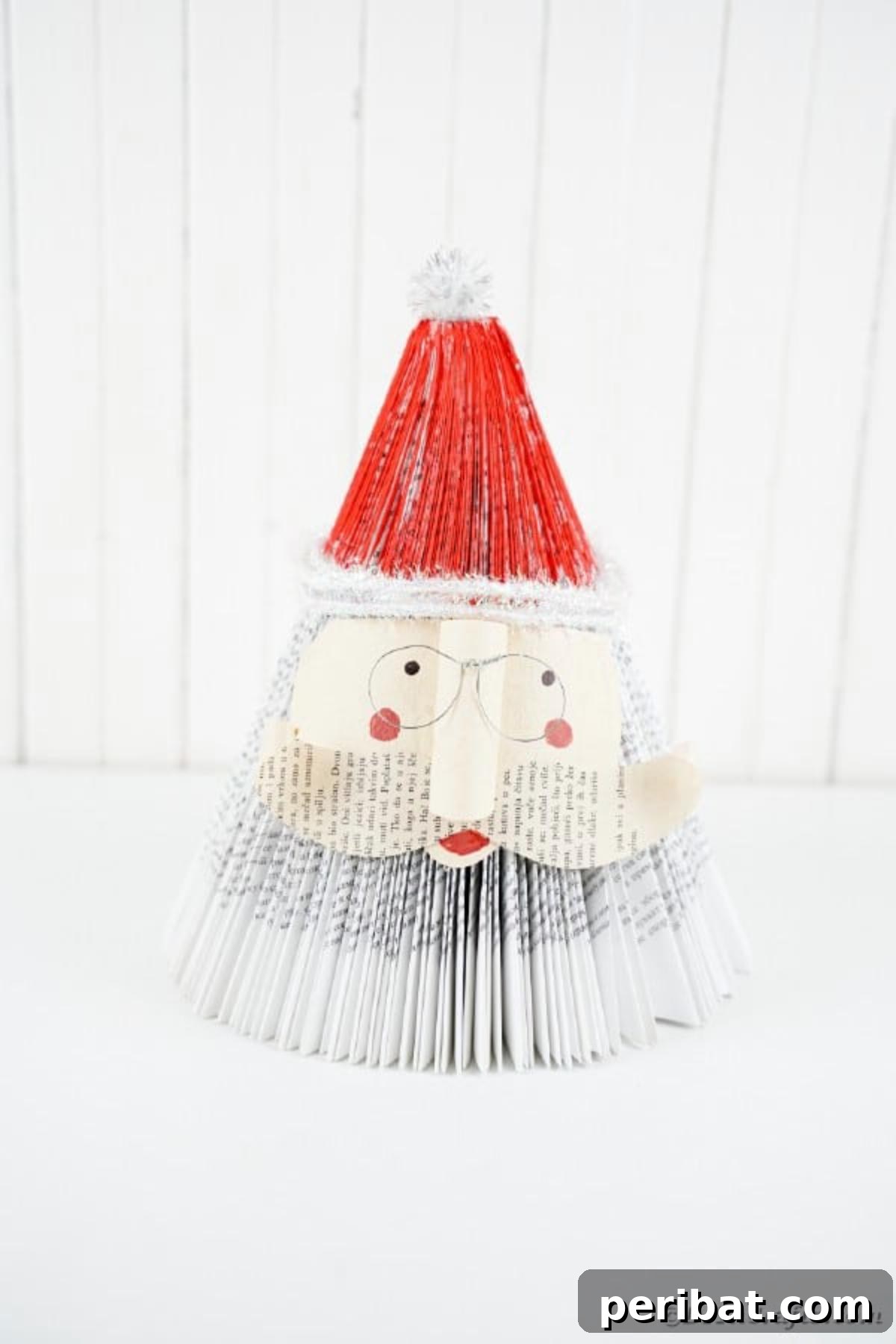 Old book Santa on white table, featuring the finished craft in a clean setting