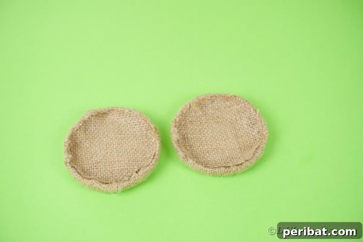 Enchanted Garden Birdcage Luminary 11 Two mason jar lids neatly wrapped with burlap fabric.