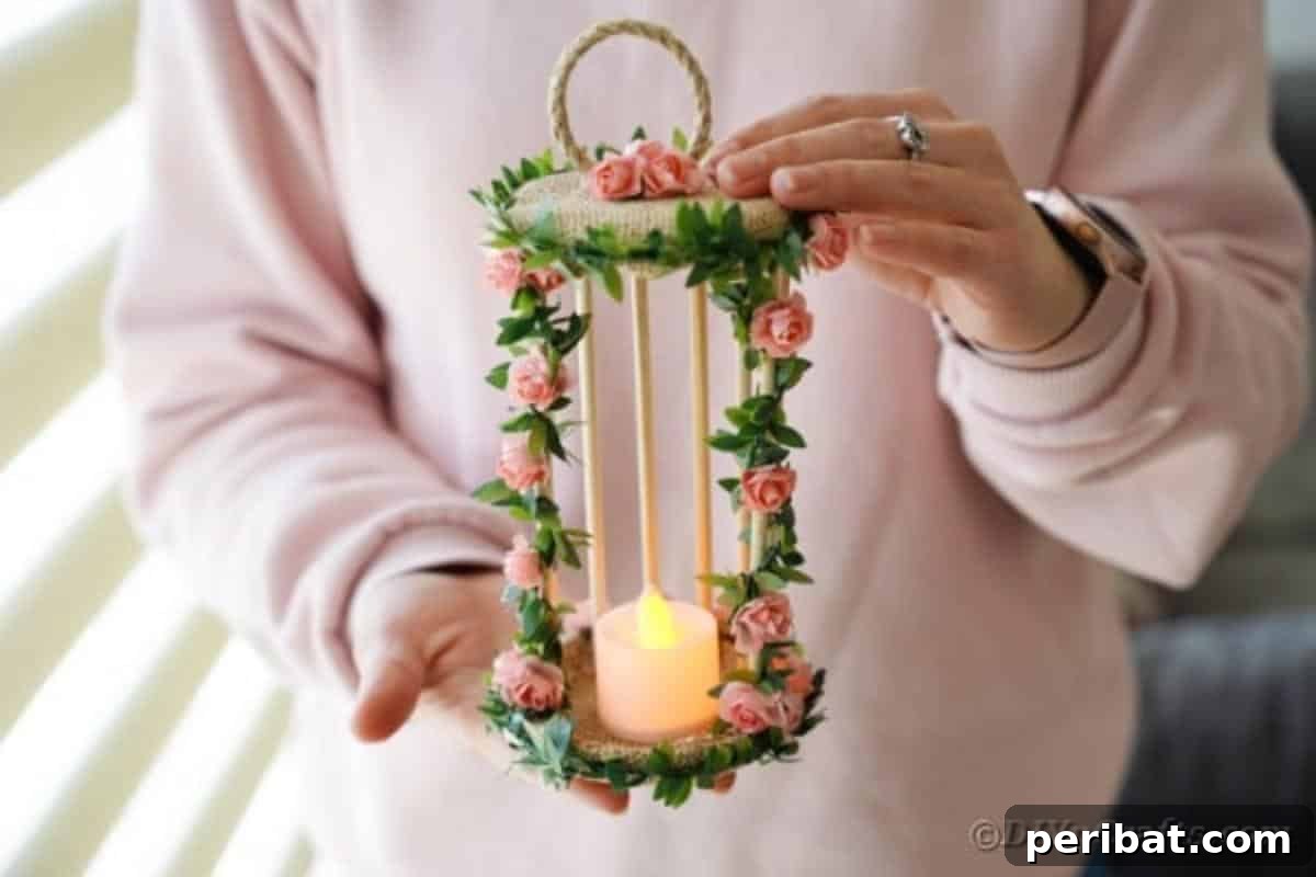 Enchanted Garden Birdcage Luminary 16 A woman proudly holding the finished DIY floral birdcage candle holder.
