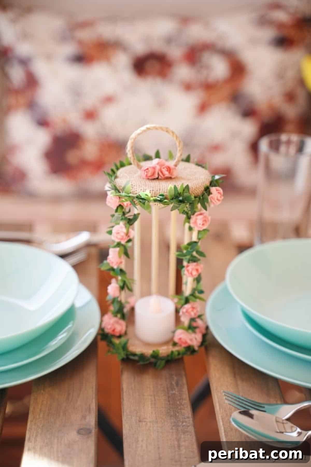 Enchanted Garden Birdcage Luminary 4 Decorative floral birdcage candle holder on a table with blue plates, showcasing its versatility as a centerpiece.