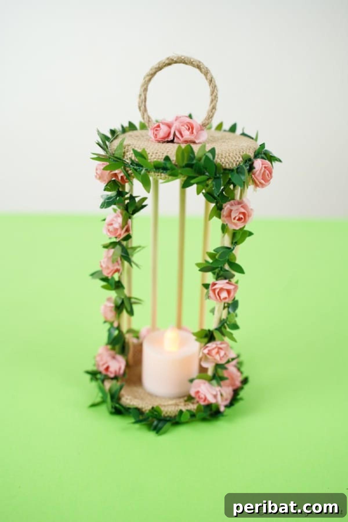 Enchanted Garden Birdcage Luminary 17 Close-up of the birdcage candle holder on a green table, featuring intricate floral details.