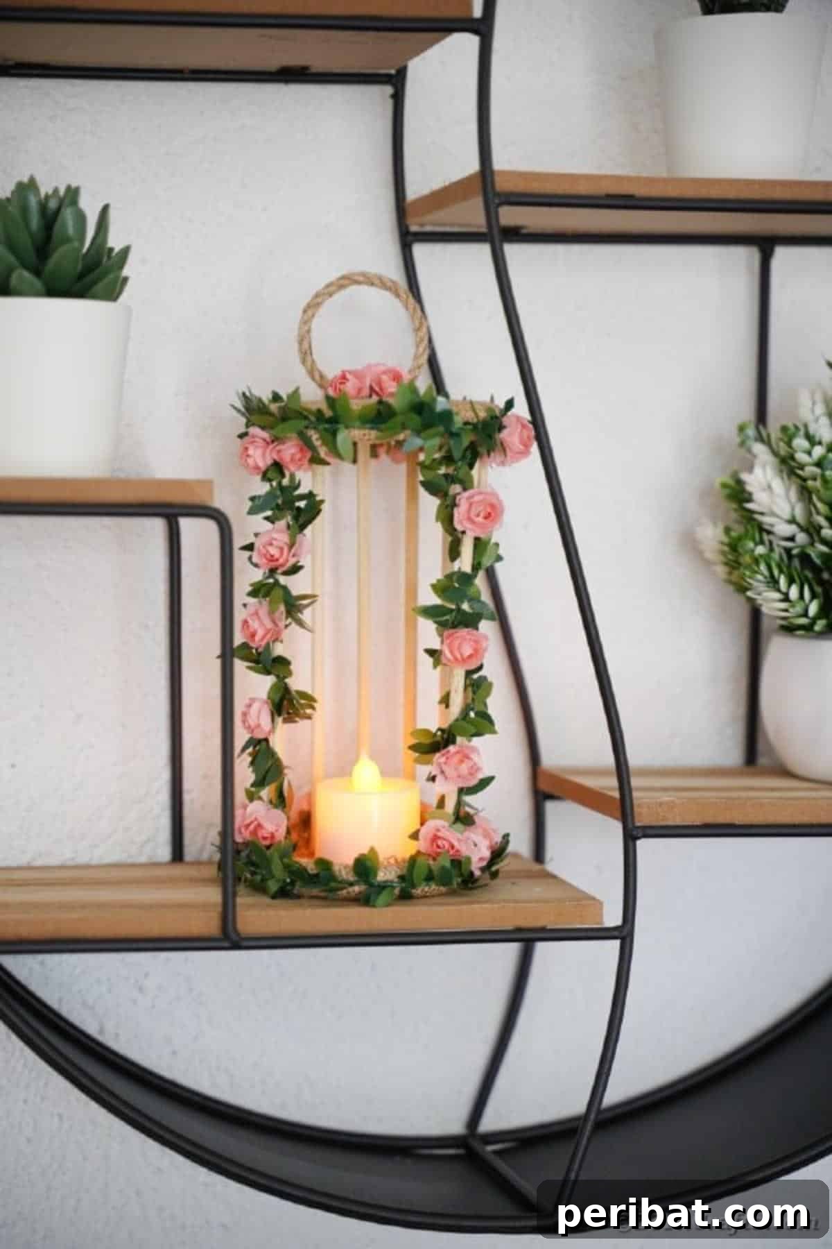 Enchanted Garden Birdcage Luminary 19 Another view of the floral birdcage candle holder on a wire shelf, highlighting its height and form.