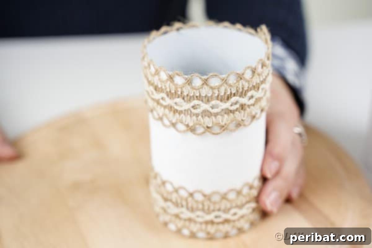 Farmhouse Storage from Repurposed Pringles Cans 13 Burlap lace being glued around the top edge of a white Pringles can