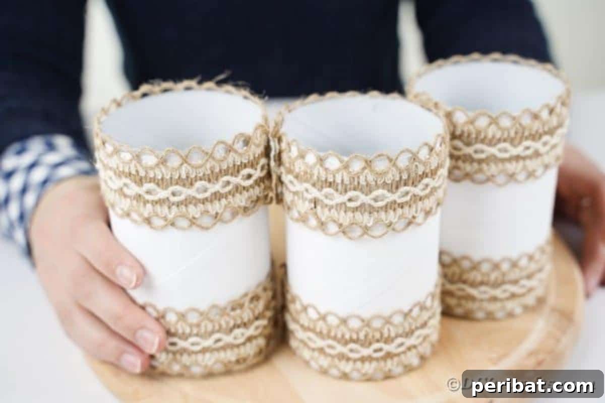 Farmhouse Storage from Repurposed Pringles Cans 15 Two white Pringles cans already glued to a wooden board, with another being attached