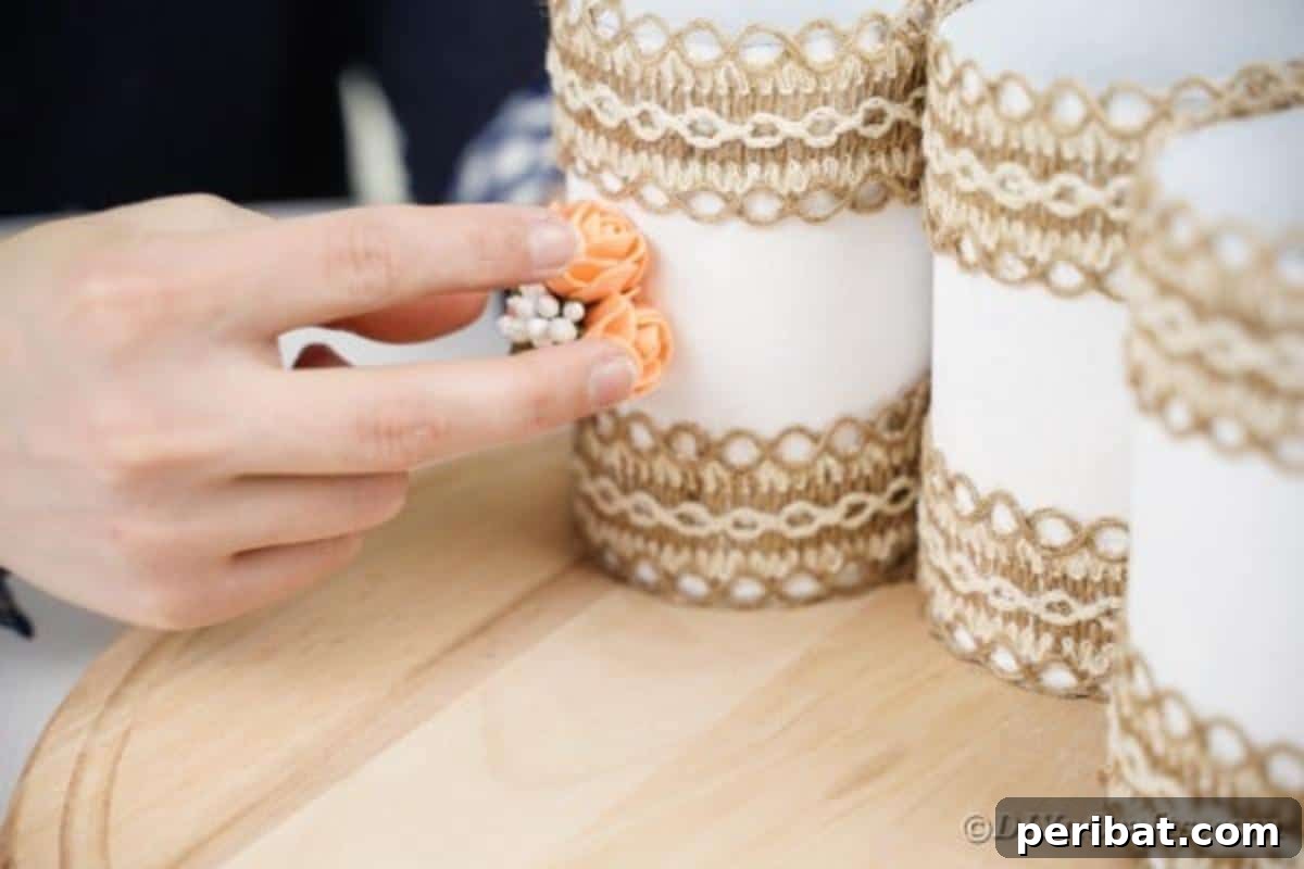 Farmhouse Storage from Repurposed Pringles Cans 16 Small artificial flowers being glued onto the center of a white Pringles can