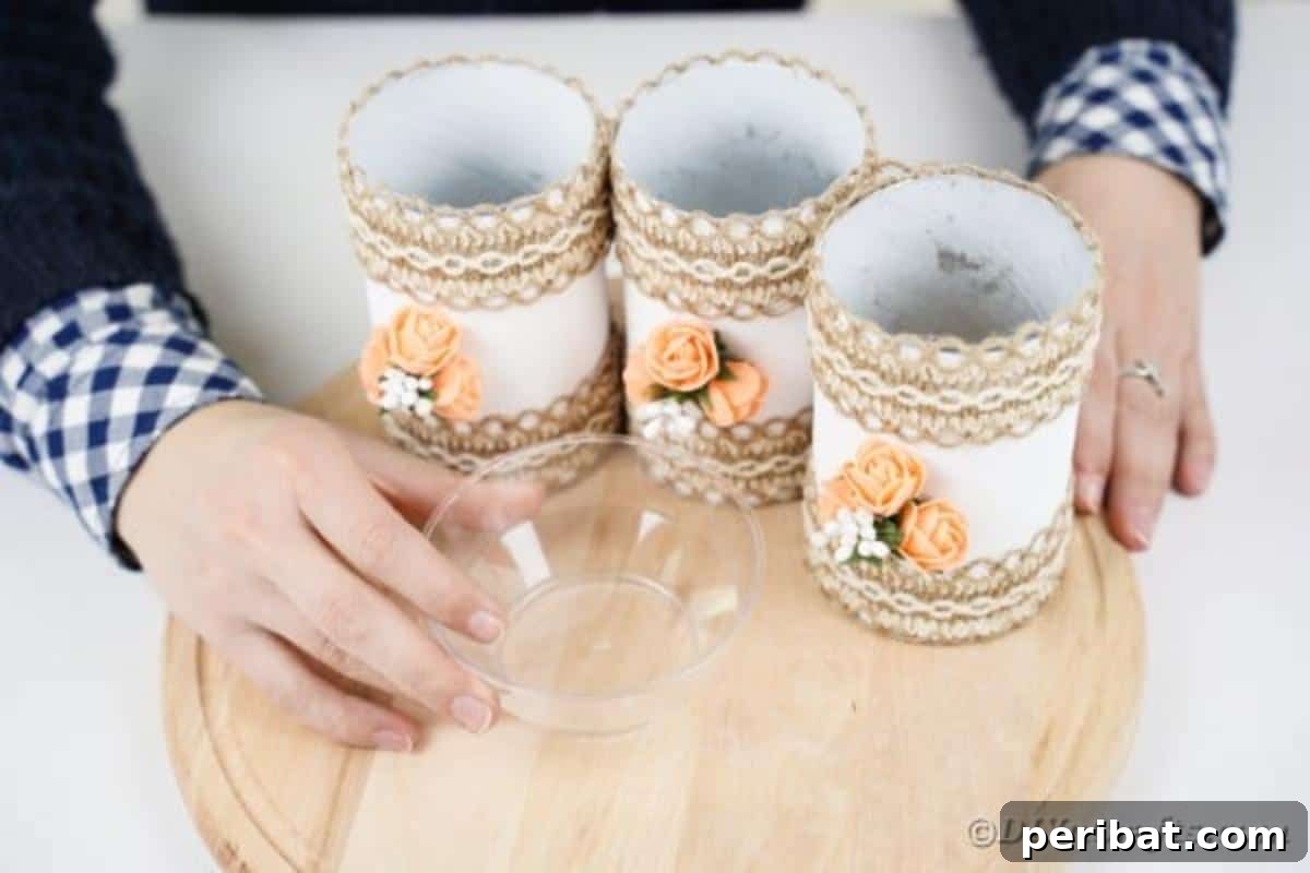 Farmhouse Storage from Repurposed Pringles Cans 17 A small clear glass bowl being glued onto the wooden board in front of the Pringles cans
