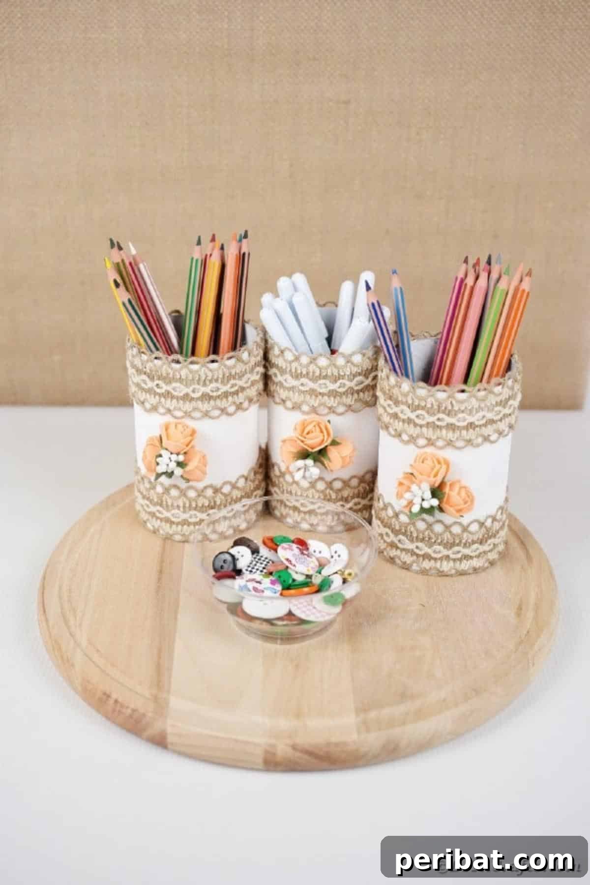 Farmhouse Storage from Repurposed Pringles Cans 18 Finished Pringles can storage containers with a clear bowl, filled with pencils and pens on a wooden board