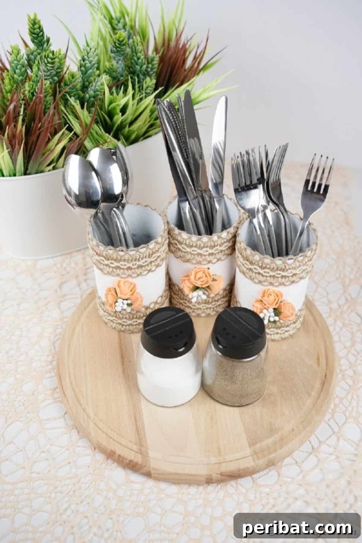 Farmhouse Storage from Repurposed Pringles Cans 4 Three Pringles can storage containers on a white table, holding kitchen utensils like spatulas and whisks
