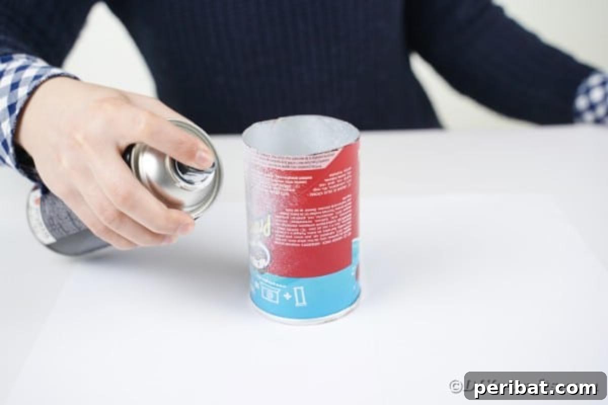 Farmhouse Storage from Repurposed Pringles Cans 10 White spray paint being applied to a Pringles can outdoors
