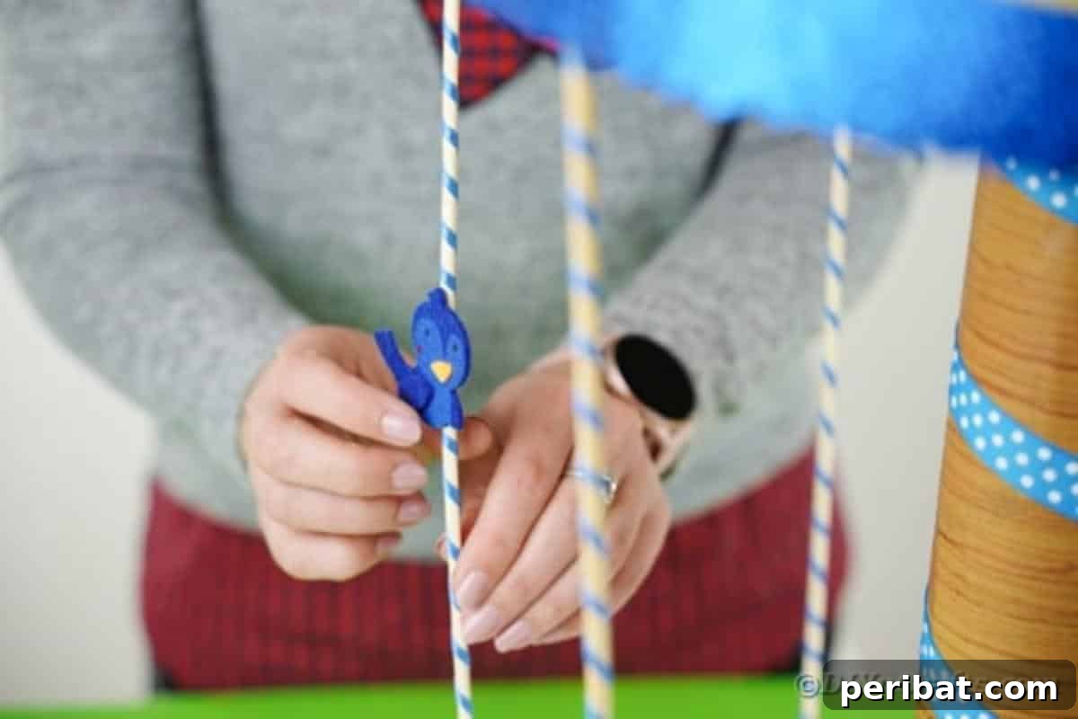 Whimsical Animal Carousel Diaper Cake 20 Decorating the carousel poles with cute animal stickers to create the rider effect