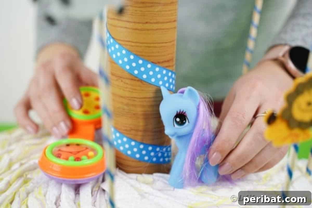 Whimsical Animal Carousel Diaper Cake 21 Arranging various baby toys and gifts on top of the diaper cake for presentation