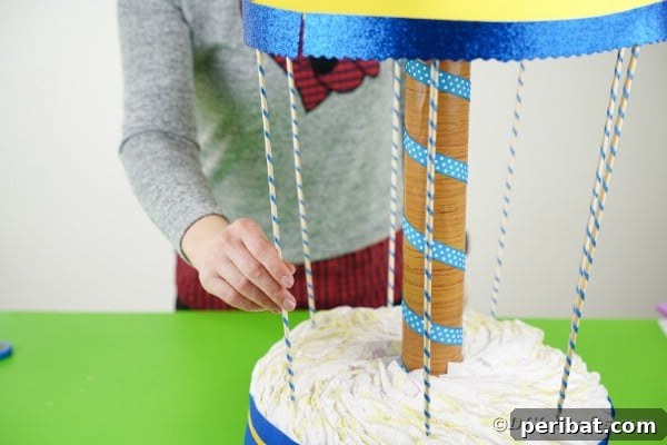 Whimsical Animal Carousel Diaper Cake 28 Placing skewers onto diaper base
