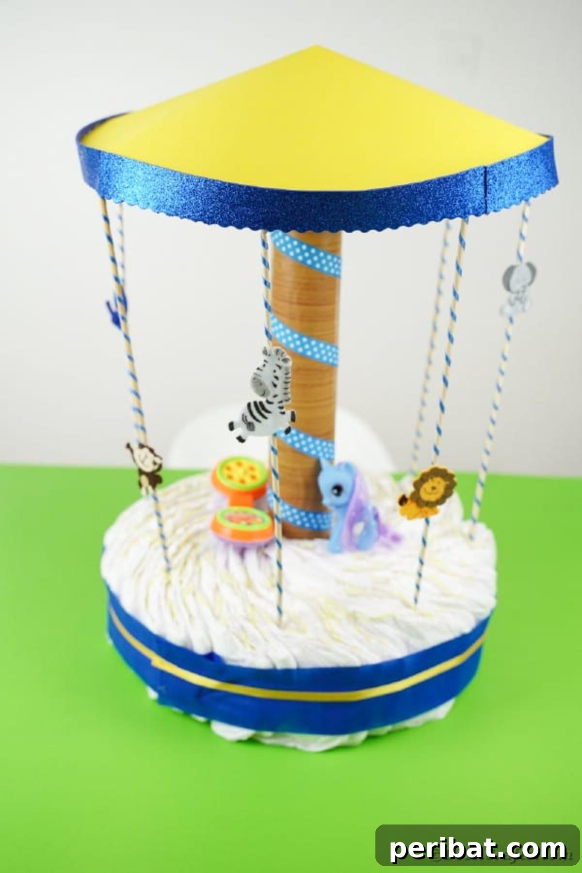 Whimsical Animal Carousel Diaper Cake 32 Completed carousel diaper cake with animal figures on a vibrant green background