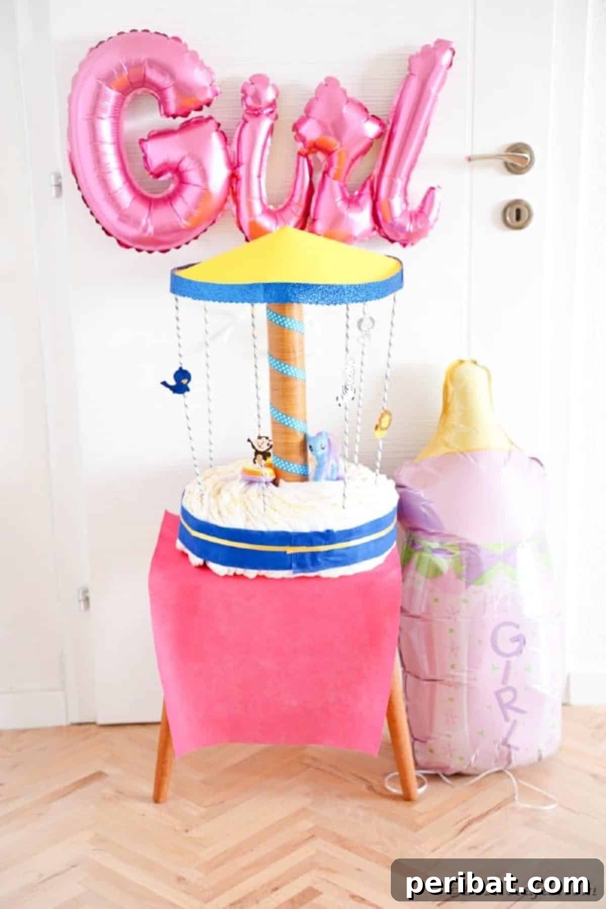 Whimsical Animal Carousel Diaper Cake 35 Carousel diaper cake with pink accents, placed on a pink table, perfect for a baby girl shower