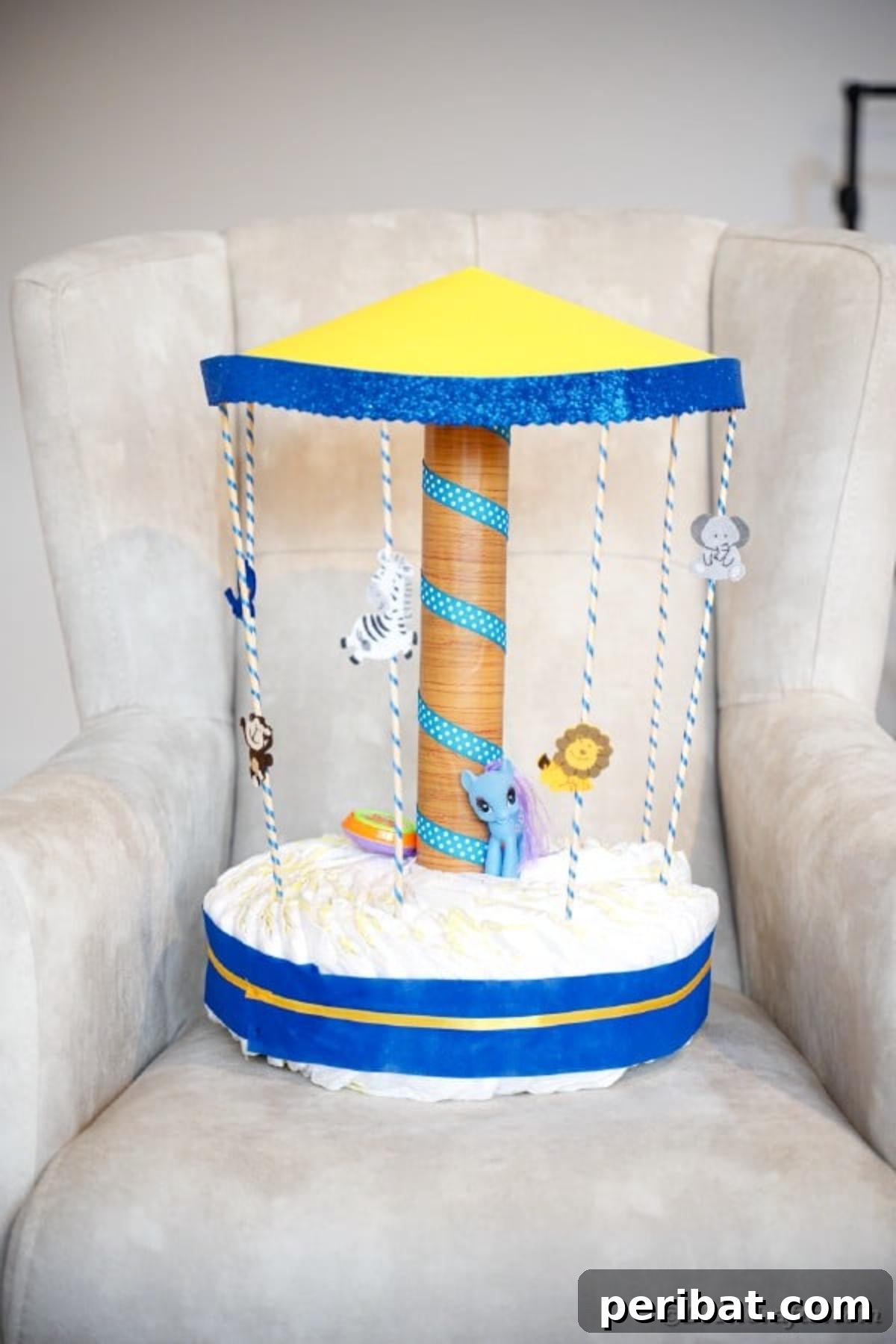 Whimsical Animal Carousel Diaper Cake 37 Detailed shot of the diaper cake carousel on a comfortable grey chair