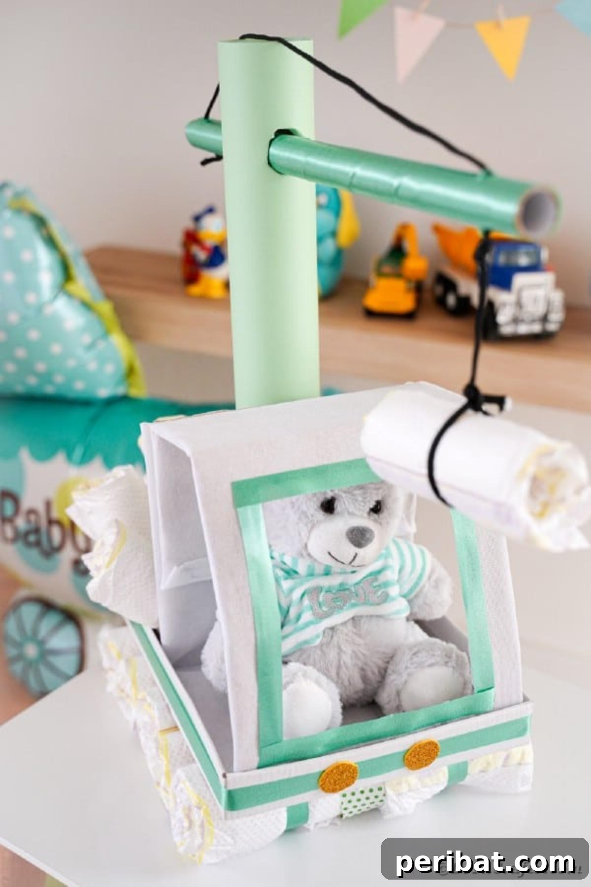 A detailed close-up photograph of the front of the crane diaper cake, highlighting the cab, headlights, and the precision of its construction.