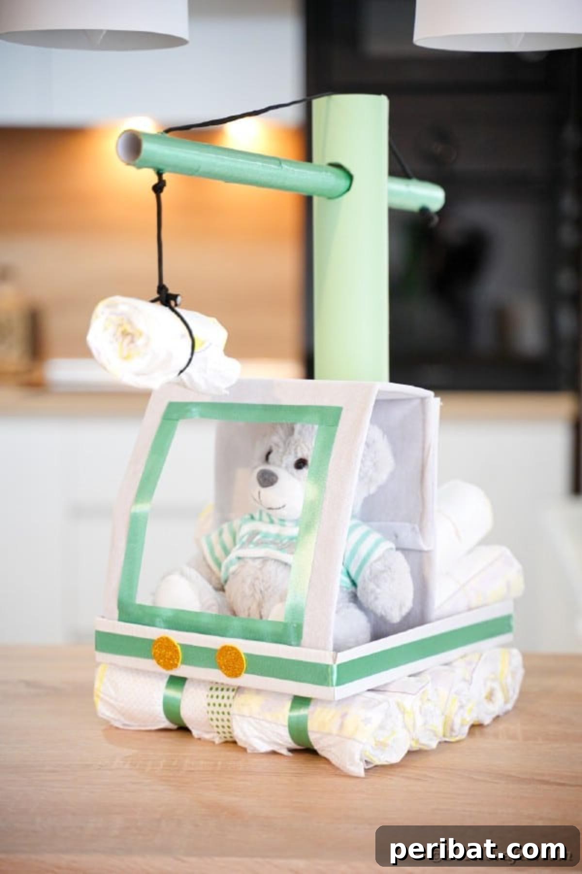 A side view of the baby crane diaper cake placed on a rustic wood table, revealing its full structure and proportions as a unique baby gift.