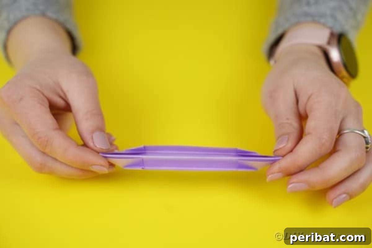 Fully folded purple paper segment, ready to become a petal.