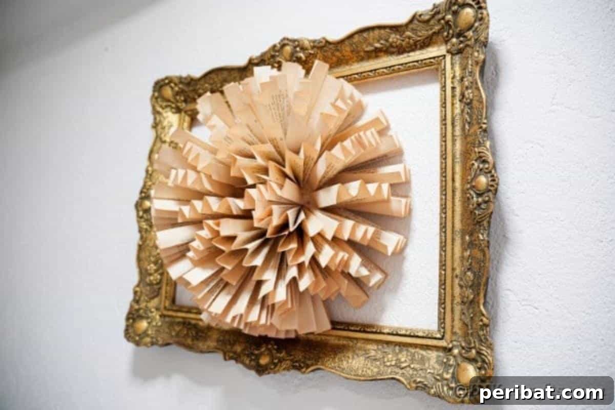 The elegant finished paper fan flower art, beautifully framed and displayed on a white wall