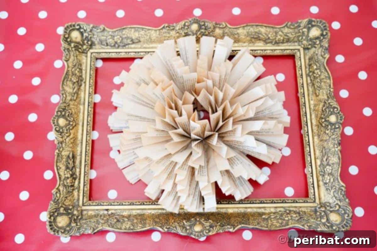 Book page paper flower art in an ornate frame against a red polka dot background