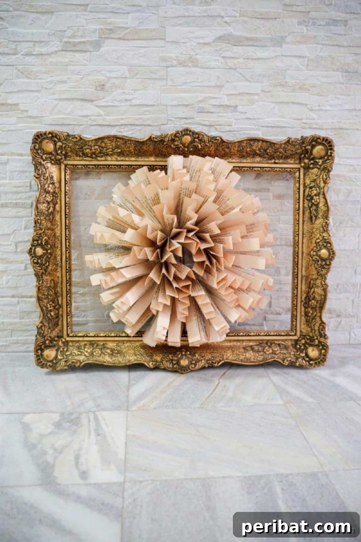 Full view of the framed paper fan flower art mounted on a rustic brick wall, displaying its full impact