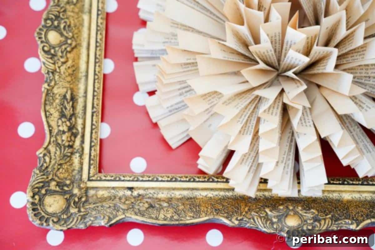 Detailed shot of a book page paper flower art in an ornate frame against a red polka dot backdrop