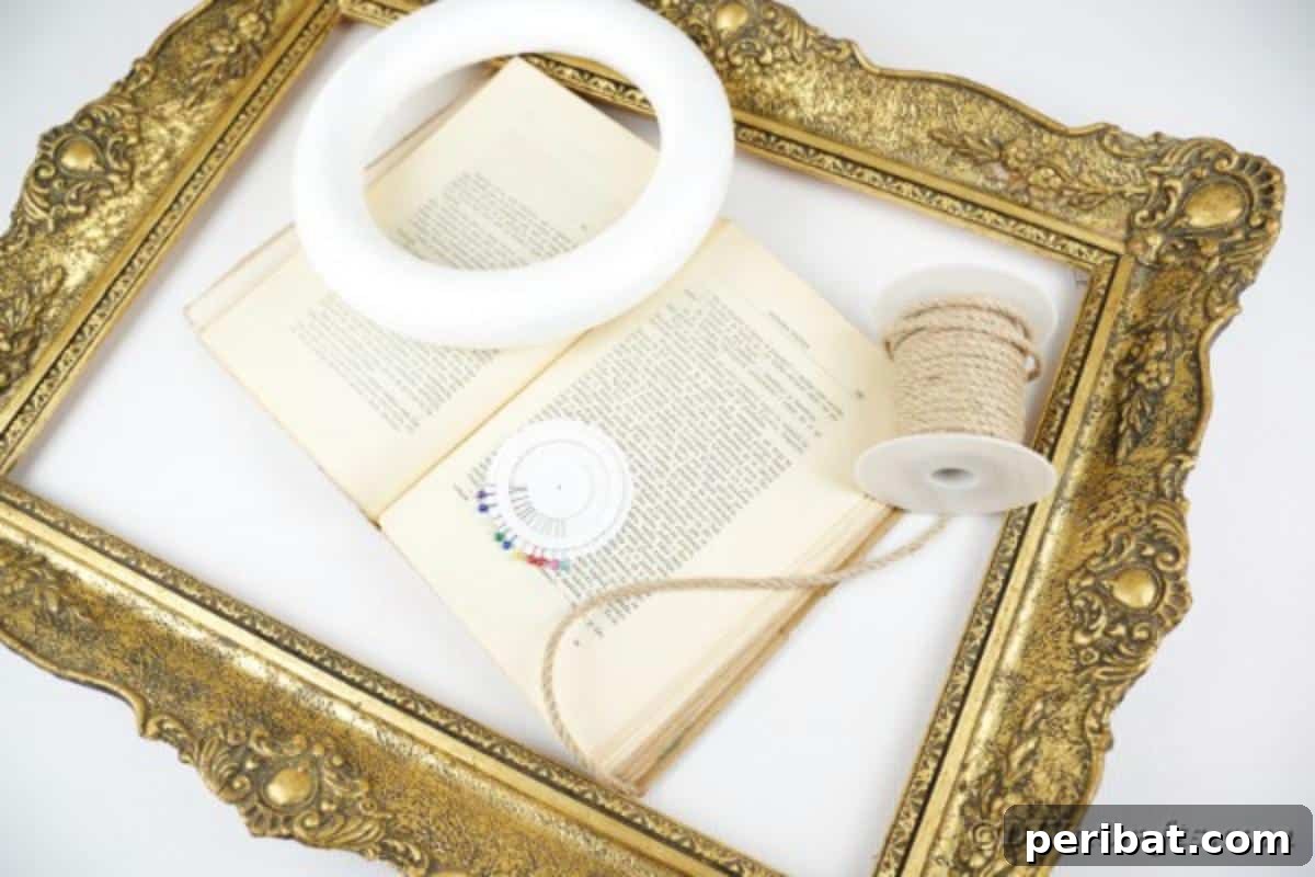 A collection of supplies neatly arranged for crafting the paper fan wall art, including old books, a wreath form, rope, and glue