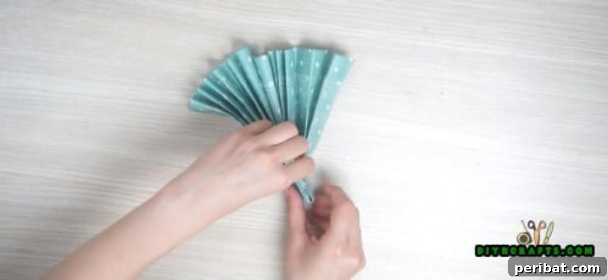 5 Instant Napkin Folds to Amaze Your Guests 19 Fan Napkin Step 3: Folding the Pleated Strip in Half