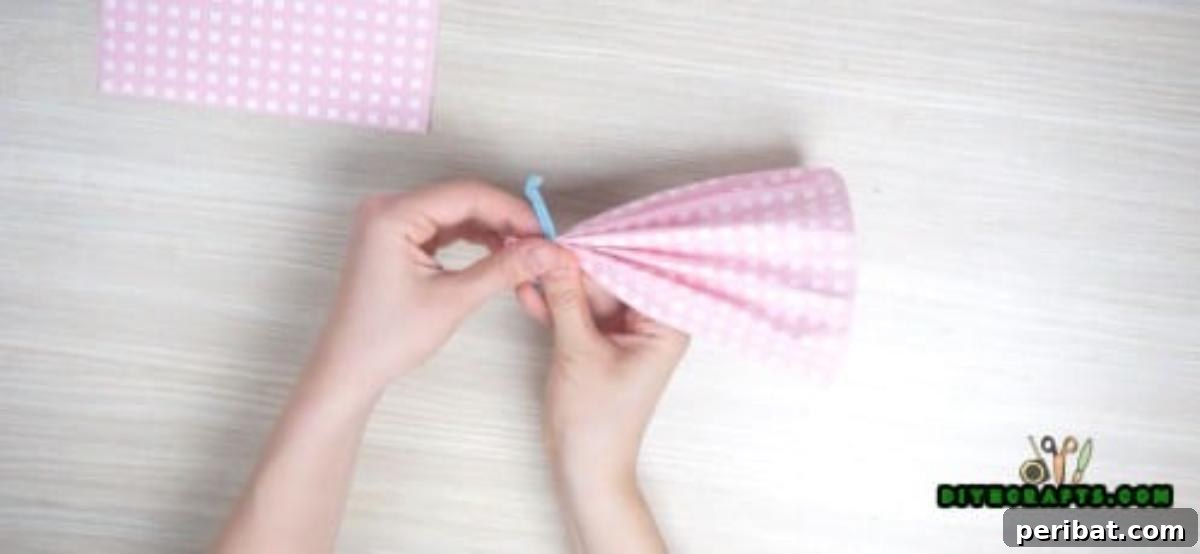 5 Instant Napkin Folds to Amaze Your Guests 23 Dress Napkin Step 2 Detail: Securing the Skirt Fan