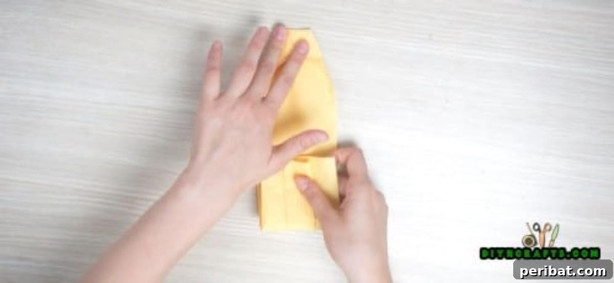 5 Instant Napkin Folds to Amaze Your Guests 38 Shirt Napkin Step 8: Folding Bottom Halfway Up