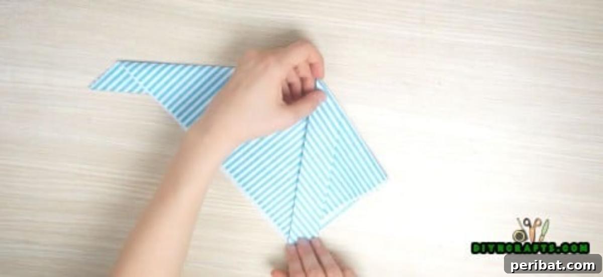 5 Instant Napkin Folds to Amaze Your Guests 6 Fish Napkin Step 4: Folding Sides to Form Body