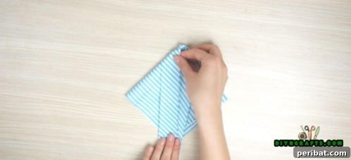 5 Instant Napkin Folds to Amaze Your Guests 7 Fish Napkin Step 4 Detail: Shaping the Fish Body